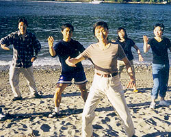 Dr. May Wang practicing Tai Chi on the beach